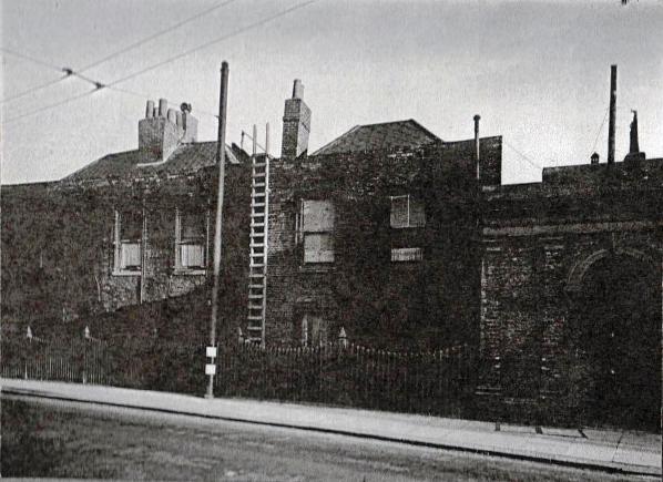 Adjoining brick buildings, two storeys, dilapidated