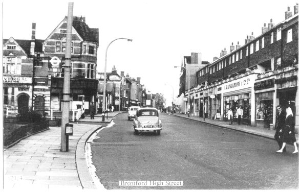 High Street view showing a couple of cars and a parade of shops