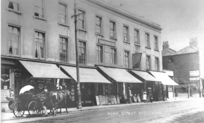 three storey property with shops, all with awnings