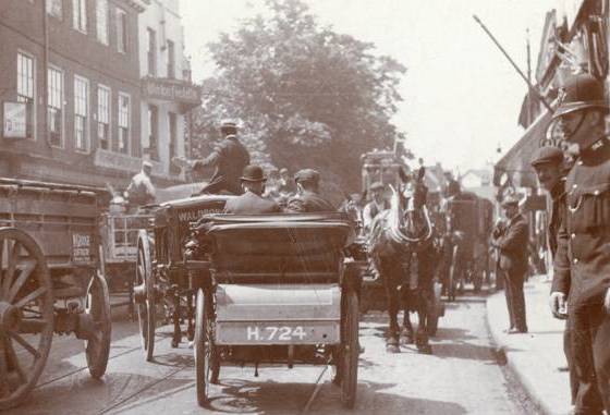 High Street congested with horsedrawn and motorised traffic