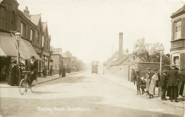 Sepia view of road with around 20 people walking, shopping, lounging on either side