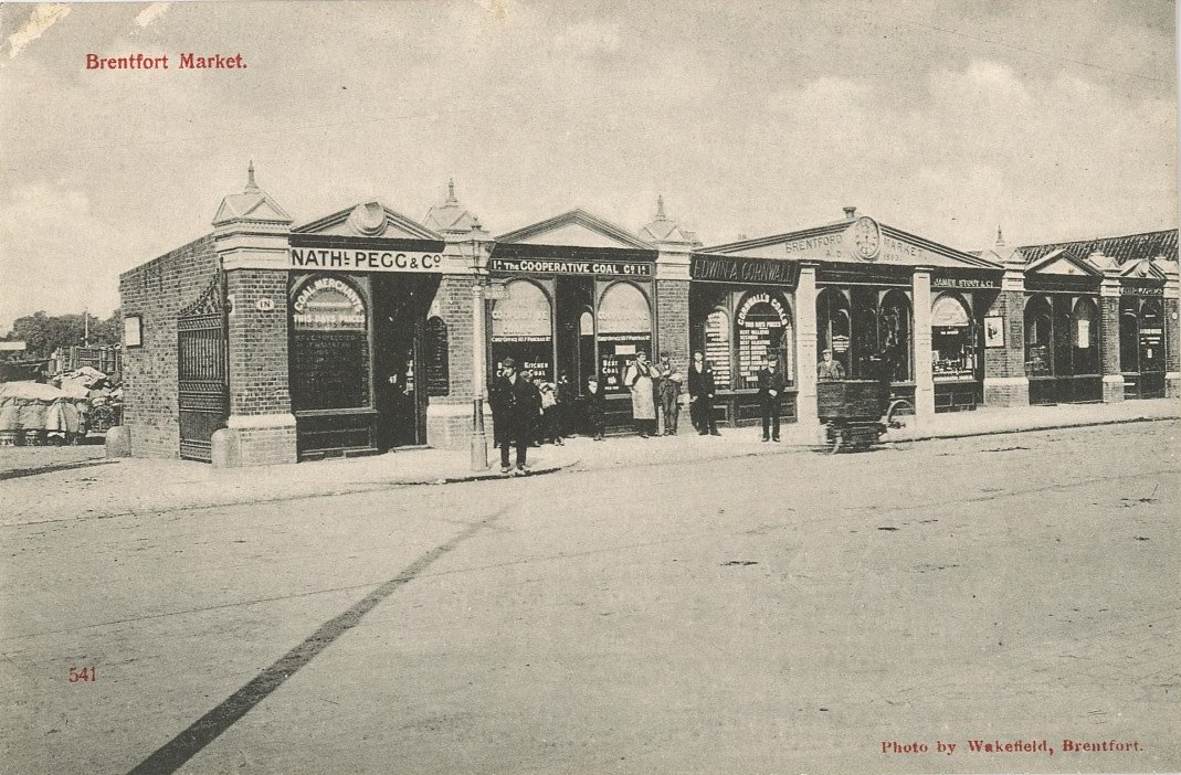 Market frontage with several people looking towards the cameraman