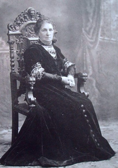 Studio portrait, Emma Phillips in ornately carved chair