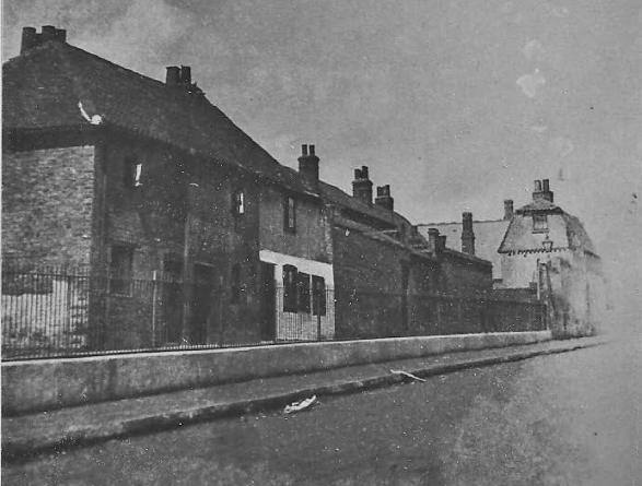 Spring Gardens, a row of houses with front railings, a foot or two above road level