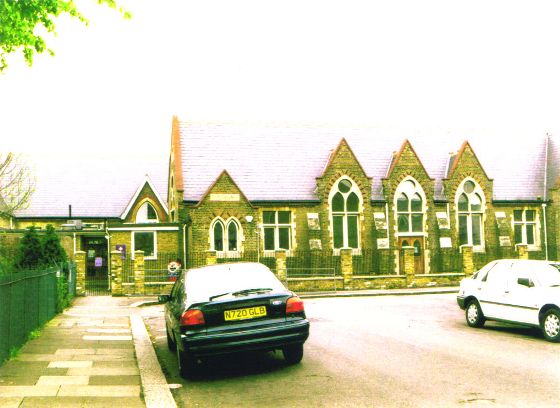 Slate roofed brick building with prominent arched windows