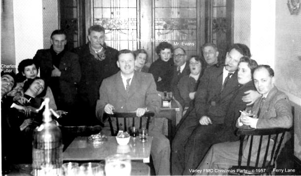 Jolly, well-wrapped up group, inside a pub